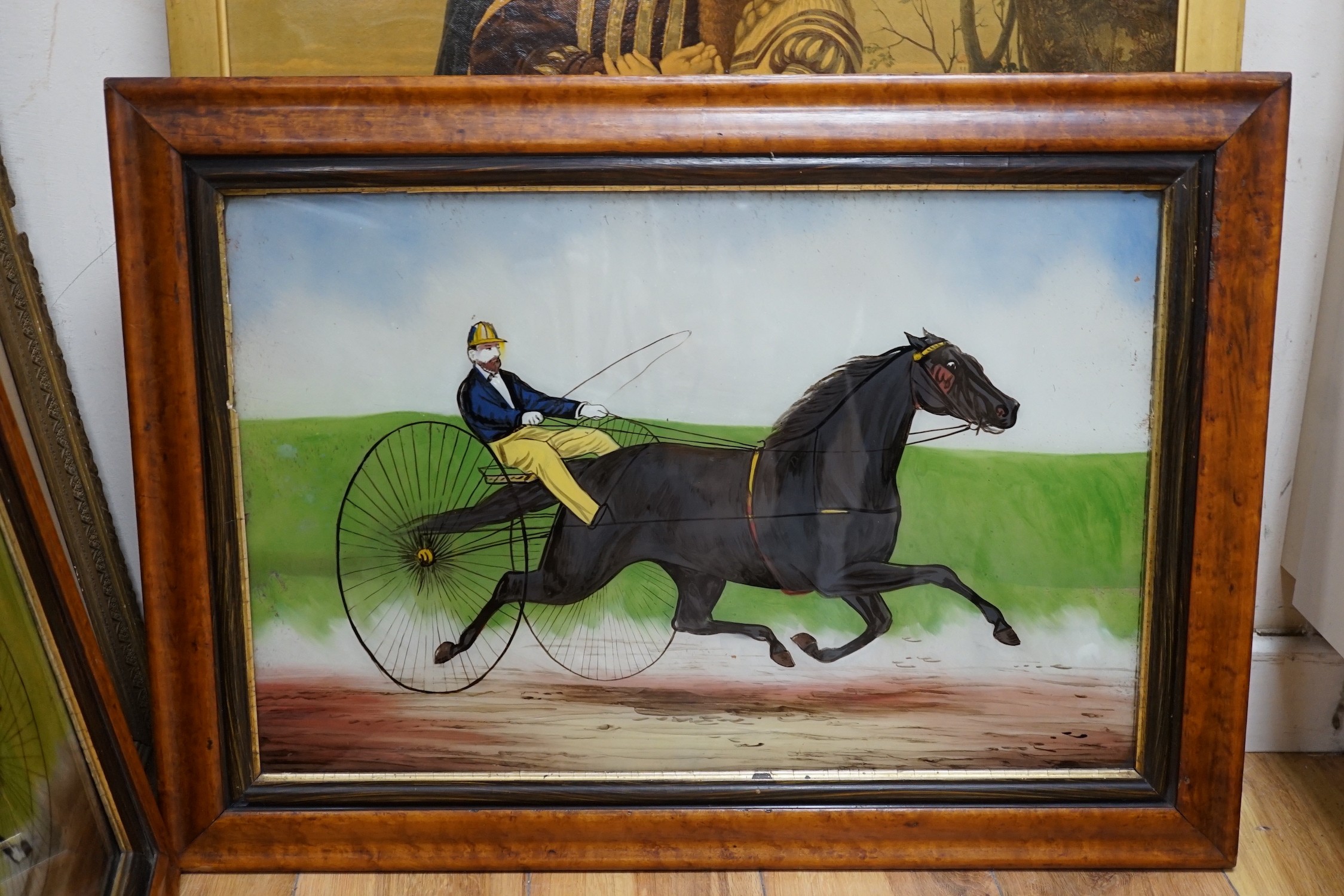 A pair of late Victorian reverse painting glass panels depicting racing gigs, 39 x 60cm, maple framed